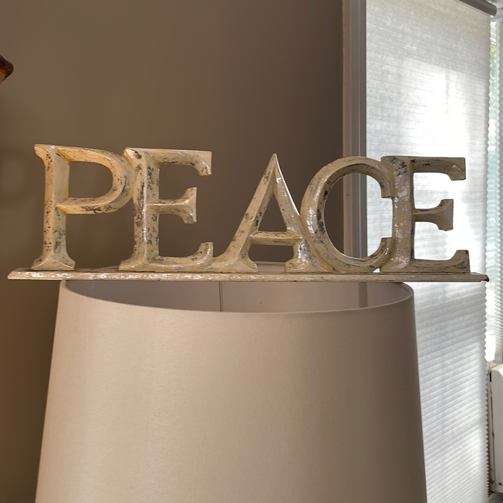 Beautiful sign on a base that says peace, very rustic shabby chic weathered look